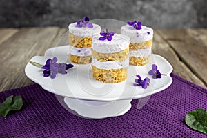 Violet flower small cakes with mascarpone purple cream