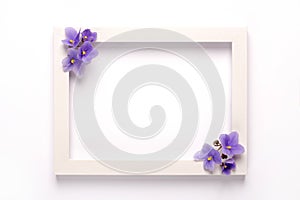 Violet flowers, photo frame on a white background.