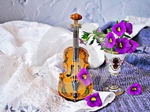 Violet flowers with violin toy on white embroidered cloth for background,Calibrachoa petunia Million bells ,Trailing petunia ,Supe