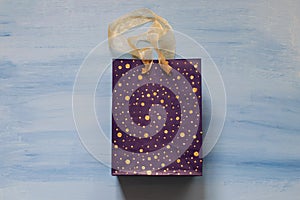 Violet gift bag on a blue background