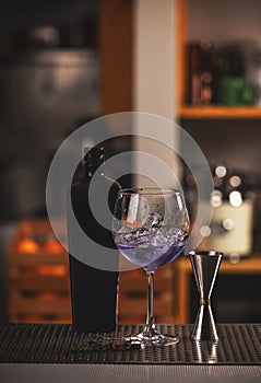 Violet gin in balloon glass