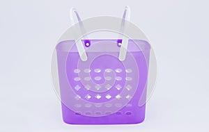 Violet plastic basket with white handles.