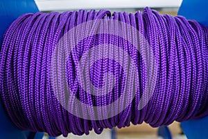 The violet rope is reeled up on the coil in shop. A saving or safety rope for climbers