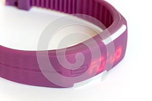 Violet rubber digital watch over white background