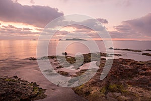 A violet sunrise on the beach of Ses figueretes, Ibiza