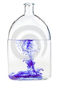 Violet watercolour dissolves in water in flask