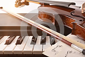 Violin and bow detail on piano keys white background front