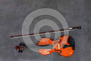 Violin and bow on gray background. Concept of classical music,