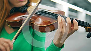 Violin and bow in the hands of a female musician