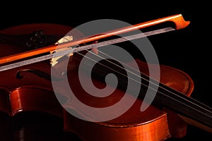 Violin and bow isolated on black
