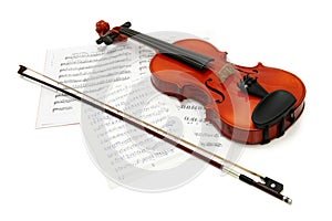 Violin with bow on music books