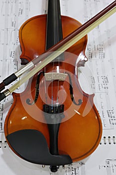 violin and bow with music partiture background