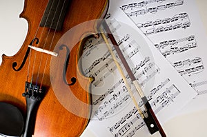 A violin and bow on sheet music