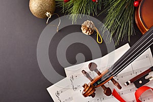 Violin with bow and sheet music on black background top