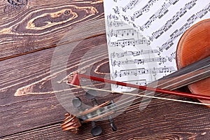Violin, fiddle stick and musical notes.