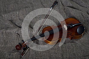 Violin, fiddlestick and bowtie, canvas background