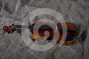 Violin, fiddlestick and bowtie, canvas background