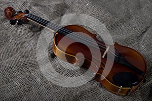 Violin, fiddlestick and bowtie, canvas background