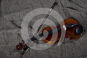 Violin, fiddlestick and bowtie, canvas background