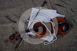 Violin, fiddlestick and bowtie, canvas background