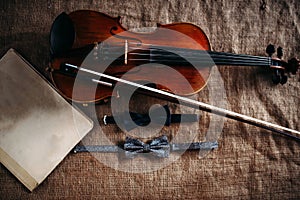 Violin, fiddlestick, notes and bowties closeup