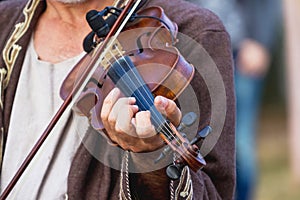 Violin in the hands of a musician during a concert