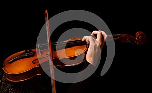 Violin in the hands of musician, isolated on black