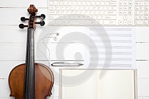 Violin with keyboard computer music paper note and notebook