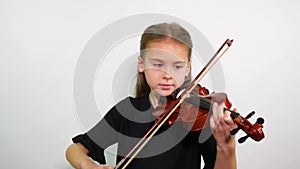 Violin lesson. The face of a girl playing a violin song