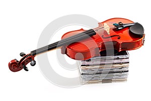 Violin lying down on CDs on wh