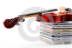 Violin lying down on CDs on wh