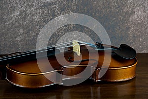 Violin Lying on a Polished Wooden Surface Closeup