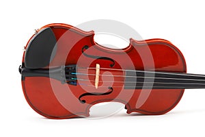 Violin lying side down on whit