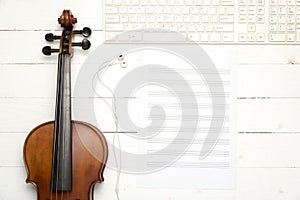 Violin with music paper note and keyboard computer