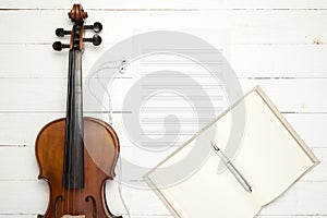 Violin with music paper note and notebook