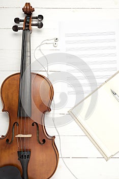Violin with music paper note and notebook