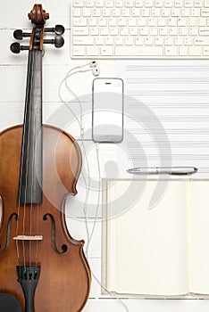 Violin with music paper note notebook and smart phone