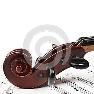 Violin with music sheet notes. Violin scroll