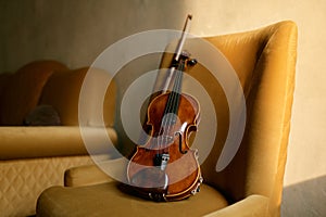 Violin musical instrument left by musician on chair