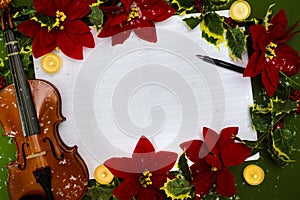 Violin and open music manuscript on the green background. Christmas concept
