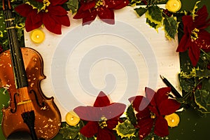 Violin and open music manuscript on the green background. Christmas concept