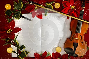 Violin and open music manuscript on the red background. Christmas concept