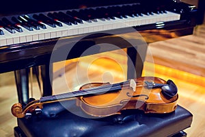 Violin and piano on wooden background