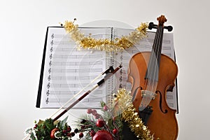 Violin and score with christmas decoration with white isolated background