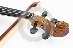 Violin Scroll with Tuning Pegs and Fiddle Bow in the background