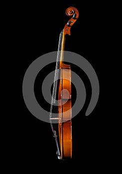 Violin side view isolated on black background.