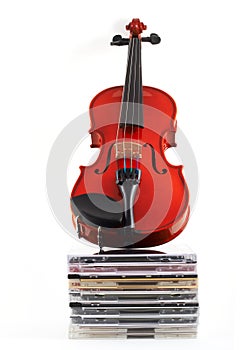 Violin standing upright on CDs
