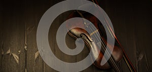 Violin in vintage style on wood background