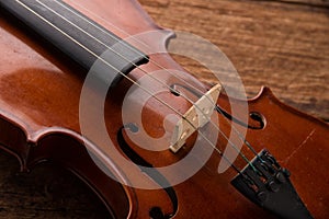 Violin in vintage style on wood background