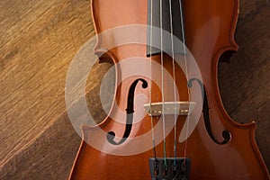 Violin in vintage style on wood background